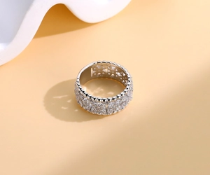 Close-up of a 925 silver four-leaf clover ring with pave-set cubic zirconia and hollow band