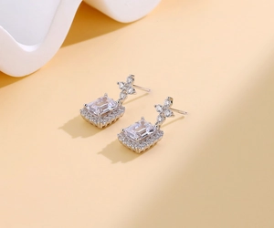 Detail of S925 silver emerald cut earring with sparkling micro-pave diamond halo