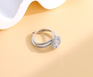 Macro detail of S925 silver halo ring featuring an oval gem and pavé diamond band