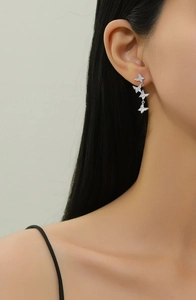 Detailed macro of S925 sterling silver butterfly tassel earrings with pavé crystals