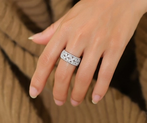 Detailed view of 925 silver wide band ring with pavé moissanite in vintage floral design