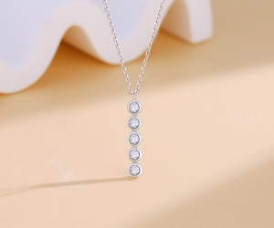 Macro shot of silver S925 necklace featuring a vertical five-stone cubic zirconia pendant