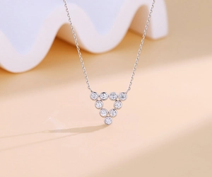 Close-up of S925 silver necklace with nine round cubic zirconia in a triangle pendant