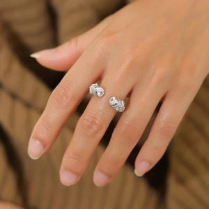 Elegant s925 silver open ring with crystal accents on a warm knit background
