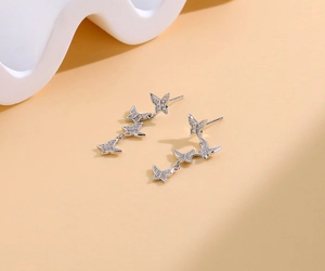 Macro view of S925 silver butterfly earrings with sparkling cubic zirconia tassels