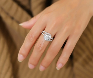 Detail of S925 sterling silver halo ring with round center stone and paved band