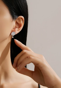 Macro shot of S925 silver square earrings with micro-pave cubic zirconia on model