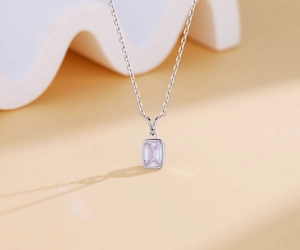 Macro view of a square emerald cut zircon pendant on a minimalist S925 silver chain