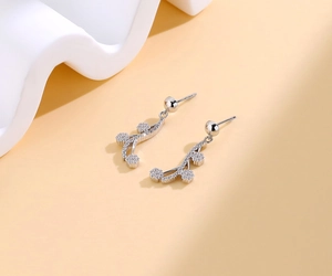 Detailed view of silver flower tassel earrings with shimmering white cubic zirconia
