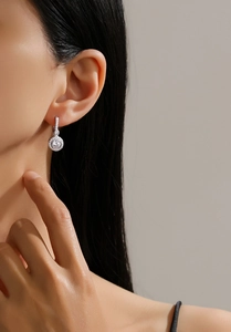 Detail of S925 sterling silver halo drop earrings with sparkling pavé cubic zirconia