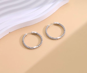 Macro shot of S925 sterling silver hoop earrings with micro-pave sparkling moissanite