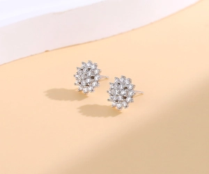 Detailed macro view of S925 sterling silver sunflower earrings with paved white zircons
