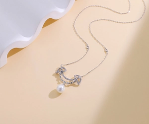 Detailed view of S925 sterling silver smile necklace with crystals and white pearl pendant