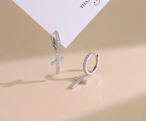 Macro shot of silver S925 cross earrings with micro-paved cubic zirconia stones