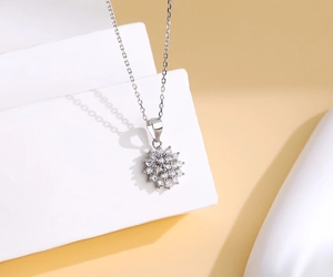 Macro detail of sparkling S925 sterling silver sunflower pendant with pavé set gemstones