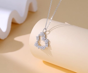 Close-up of S925 silver heart necklace with star elements and sparkling pavé stones