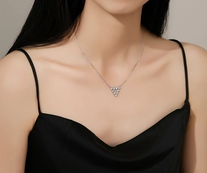 Close-up of a S925 sterling silver necklace with a triangle bead pendant on a model