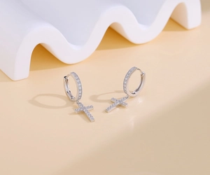 Close-up of S925 silver hoop earrings with pavé cubic zirconia cross pendants