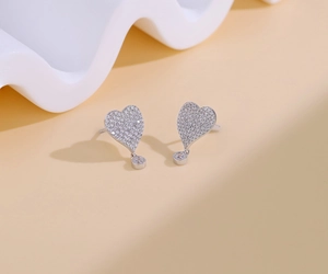 Detailed view of S925 sterling silver heart studs with pavé micro-inlaid cubic zirconia