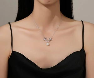 Detail of S925 sterling silver smile necklace with pearl pendant and pavé crystals