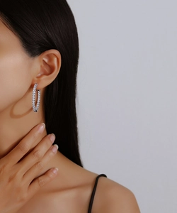 Close-up of elegant S925 sterling silver hoop earrings with pavé set moissanite stones