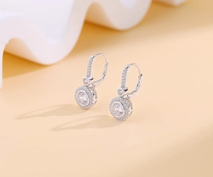 Macro detail of S925 sterling silver drop earrings with halo micro-set cubic zirconia
