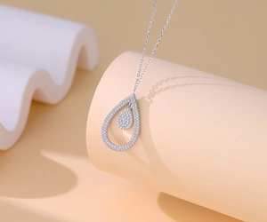 Macro detail of S925 silver double teardrop pendant necklace with micro-pave zircons