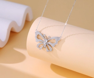 Macro detail of silver hollow butterfly pendant necklace with sparkling pavé zircons