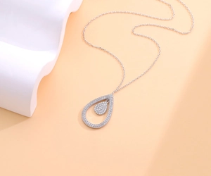 Close-up of S925 silver double water drop pendant with sparkling pavé cubic zirconia