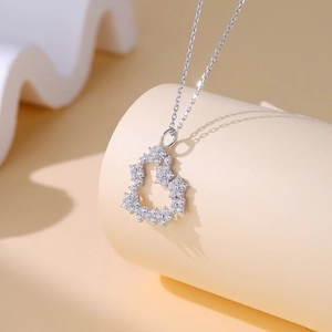 Elegant S925 sterling silver heart necklace with micro-pave crystals on a display stand