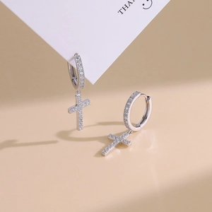 Classic S925 silver hoop earrings with micro-set zircon cross charms on beige background