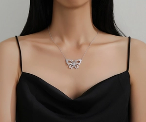 Exquisite hollow butterfly necklace with sparkling stones worn by a model on the collarbone