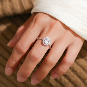 S925 sterling silver ring with 1ct oval moissanite in a twisted halo setting on hand