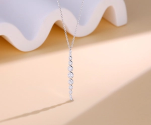 Macro view of S925 silver necklace featuring a vertical tassel pendant with nine round zircons