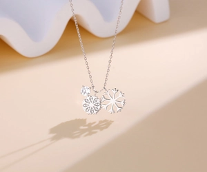 Close-up of a silver snowflake necklace with a crystal pendant and sparkling micro-diamonds