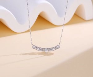 Macro detail of S925 sterling silver wave necklace with pavé-set sparkling zircons