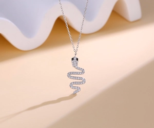 Macro detail of S925 sterling silver snake pendant encrusted with sparkling white zircons