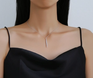 Detail of S925 sterling silver necklace with round cubic zirconia tassel pendant on model