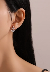 Close-up of S925 sterling silver anchor earrings with micro-pave crystals on the ear