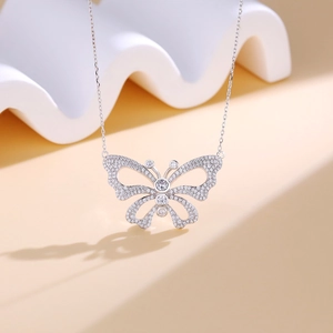 Hollow butterfly pendant necklace with white micro-inlaid stones in silver finish