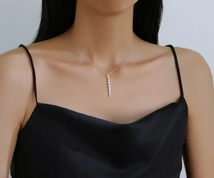 Detailed view of S925 sterling silver necklace with sparkling zircon tassel pendant on neck