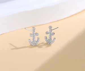 Close-up of S925 sterling silver anchor stud earrings with pavé-set shimmering cubic zirconia