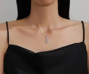 Close-up of a S925 silver snake pendant necklace with pavé zircons on a model