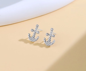 Macro shot of S925 sterling silver anchor earrings with sparkling cubic zirconia pavé setting