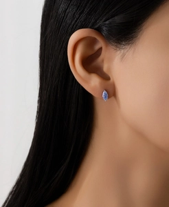 Close-up of S925 silver earring with marquise-cut sea blue moissanite worn by a model