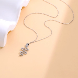 S925 sterling silver snake necklace with cubic zirconia on a minimalist cream background