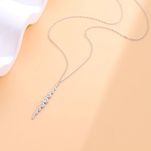 S925 sterling silver necklace with round zircon tassel pendant on orange background
