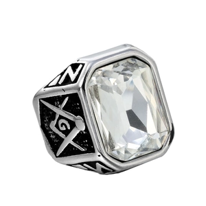Macro detail of silver stainless steel ring with masonic symbols and clear rectangular stone