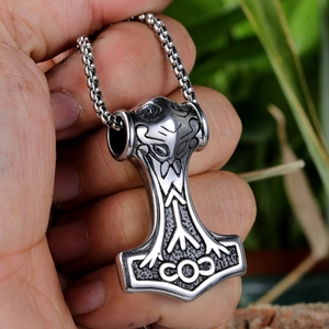 Macro shot of vintage silver stainless steel Thor's hammer pendant with rune engravings