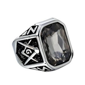 Detail of a Masonic signet ring with a smoky grey stone and engraved compass symbol